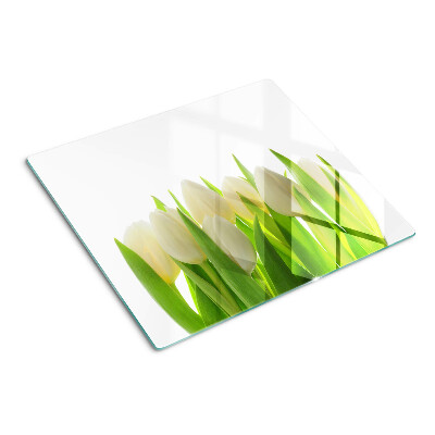 Tabla de cortar de cristal Tulipanes sobre un fondo de hojas verdes.