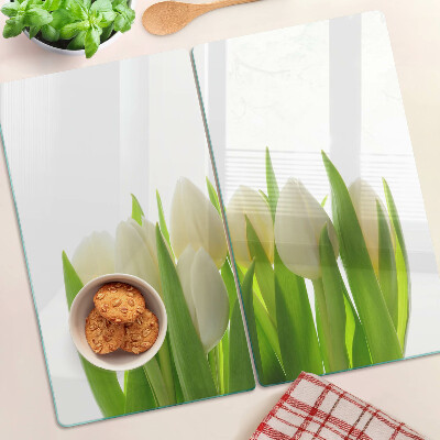 Tabla de cortar de cristal Tulipanes sobre un fondo de hojas verdes.