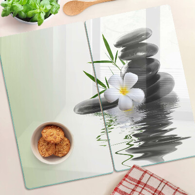 Tabla de cortar de cristal Flores y piedras en el agua