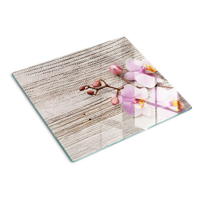 Tabla de cortar de cristal Orquídeas sobre un fondo de madera