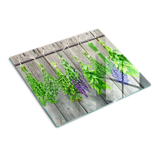 Tabla de cortar de cristal Hierbas secas sobre un fondo de madera