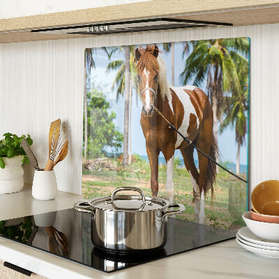Tabla de cortar de cristal Un caballo con palmeras al fondo.