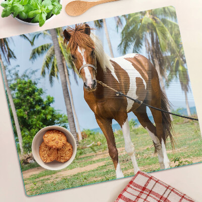 Tabla de cortar de cristal Un caballo con palmeras al fondo.