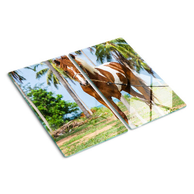 Tabla de cortar de cristal Un caballo con palmeras al fondo.