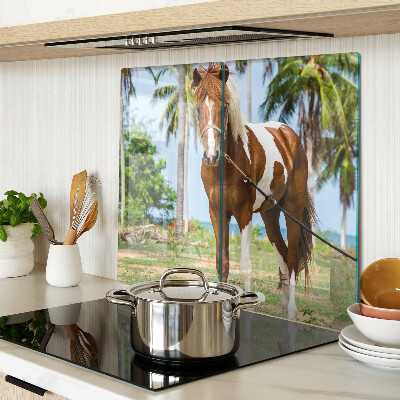 Tabla de cortar de cristal Un caballo con palmeras al fondo.