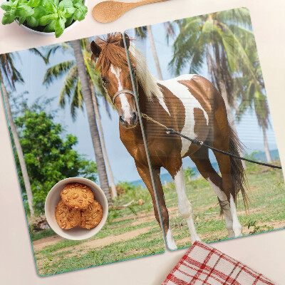 Tabla de cortar de cristal Un caballo con palmeras al fondo.