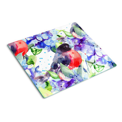 Tabla de cortar de cristal Pájaro sobre un fondo de flores.