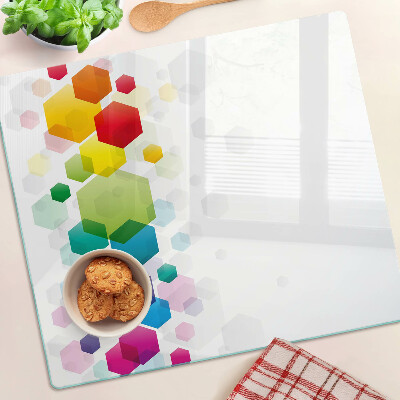 Tabla para cortar Hexágonos coloridos en el fondo.
