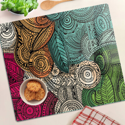 Tabla de cortar de cristal Motivo de mandala con patrones coloridos.