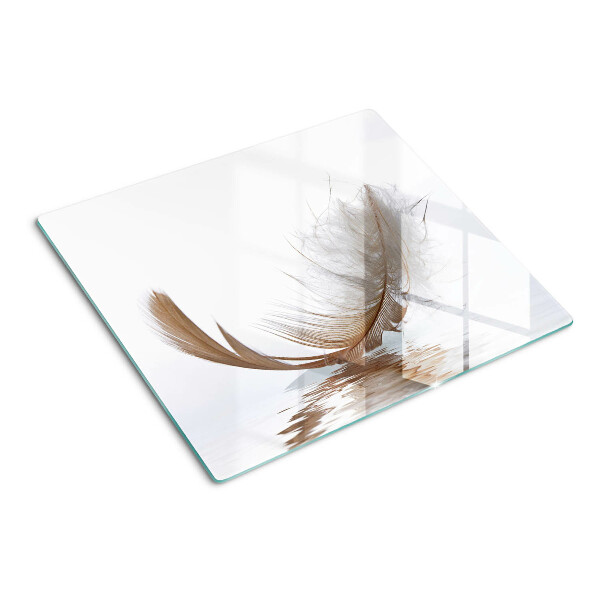 Tabla de cortar de cristal Pluma sobre el fondo del agua