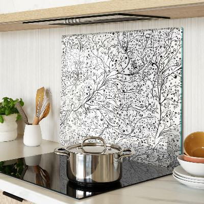 Tabla de cortar de cristal Un patrón de planta con ramas delicadas.