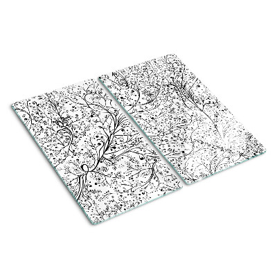 Tabla de cortar de cristal Un patrón de planta con ramas delicadas.