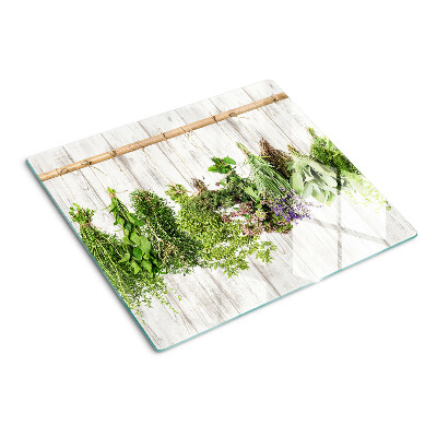 Tabla de cortar de cristal Hierbas sobre un fondo de madera