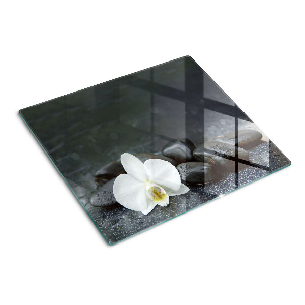Tabla para cortar Flor de orquídea sobre piedras