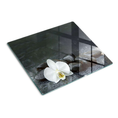 Tabla para cortar Flor de orquídea sobre piedras