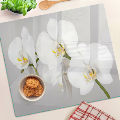 Tabla de cortar de cristal Orquídeas sobre un fondo de espejo