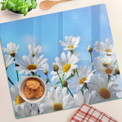 Tabla para cortar Flores de margarita sobre un fondo azul