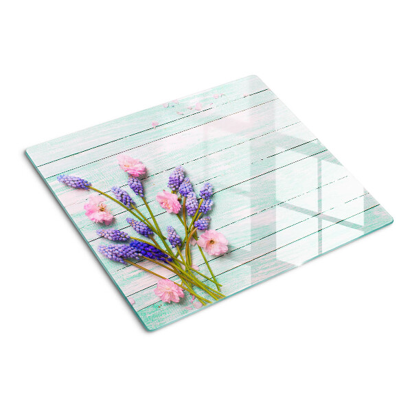 Tabla de cortar de cristal Flores sobre un fondo de madera