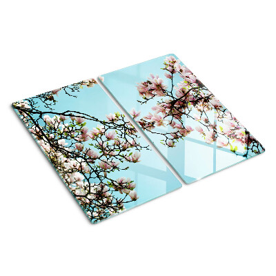 Tabla para cortar Flores de magnolia sobre fondo azul.