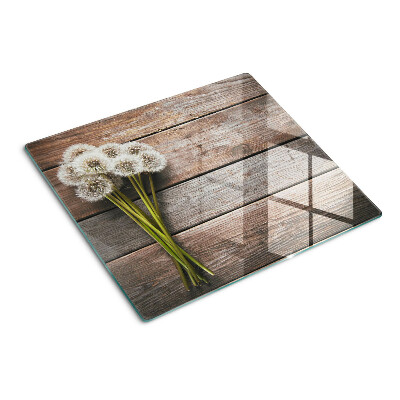 Tabla para cortar Flores de diente de león sobre un fondo de madera