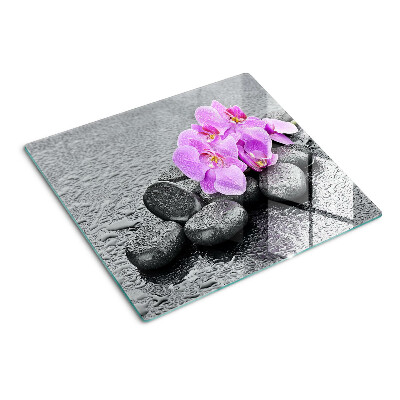 Tabla de cortar de cristal Flores y piedras contra el agua.