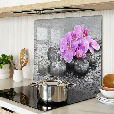 Tabla de cortar de cristal Flores y piedras contra el agua.