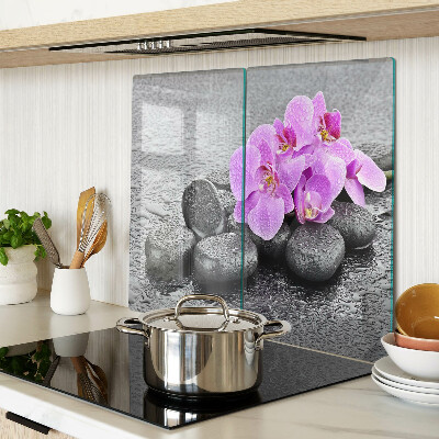 Tabla de cortar de cristal Flores y piedras contra el agua.