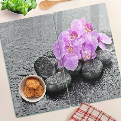 Tabla de cortar de cristal Flores y piedras contra el agua.