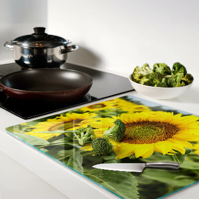 Tabla de cortar de cristal Girasoles sobre un fondo verde