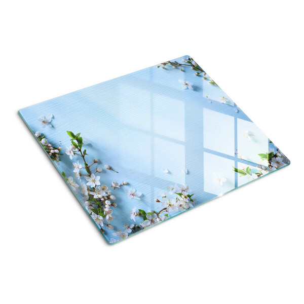 Tabla de cortar de cristal Patrón floral sobre fondo azul.