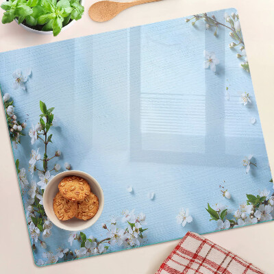 Tabla de cortar de cristal Patrón floral sobre fondo azul.