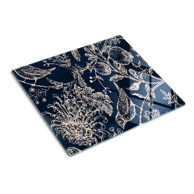 Tabla de cortar de cristal Flores y pájaros sobre un fondo oscuro.