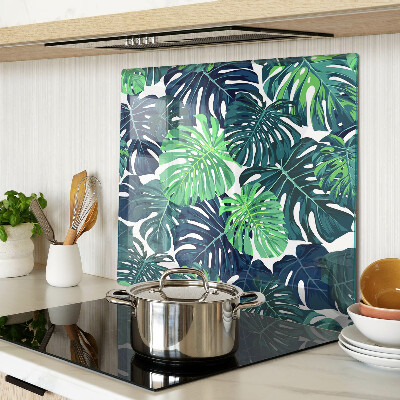 Tabla para cortar Hojas de monstera sobre un fondo tropical