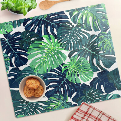 Tabla para cortar Hojas de monstera sobre un fondo tropical