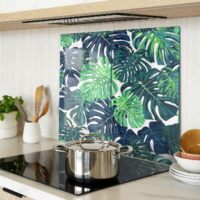 Tabla para cortar Hojas de monstera sobre un fondo tropical