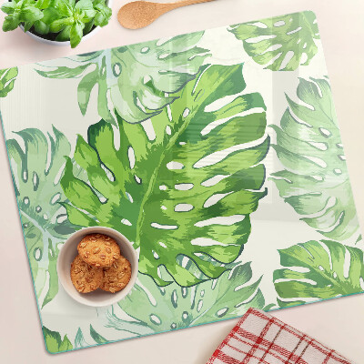 Tabla para cortar Hojas de monstera sobre un fondo claro