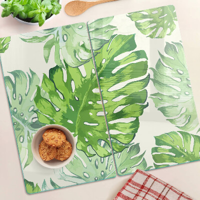 Tabla para cortar Hojas de monstera sobre un fondo claro