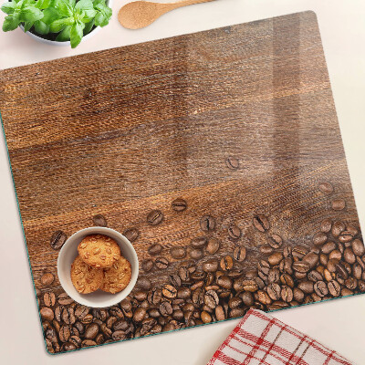 Tabla de cortar de cristal Granos de café sobre fondo de madera