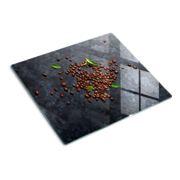Tabla de cortar de cristal Granos de café sobre un fondo de piedra