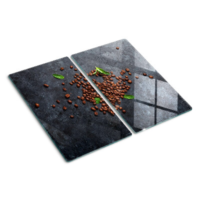 Tabla de cortar de cristal Granos de café sobre un fondo de piedra