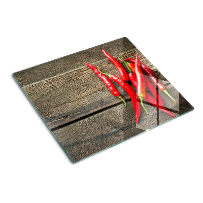 Tabla de cortar de cristal Chiles sobre un fondo de madera