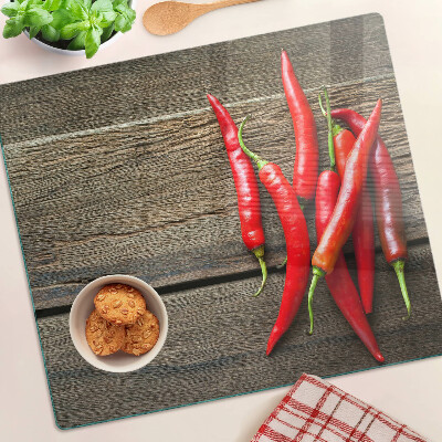 Tabla de cortar de cristal Chiles sobre un fondo de madera