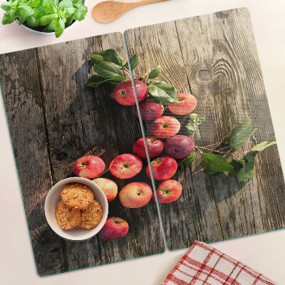 Tabla de cortar de cristal Manzanas sobre un fondo de madera