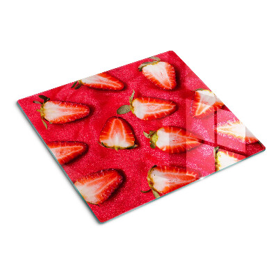 Tabla de cortar de cristal Fresas sobre un fondo rosa