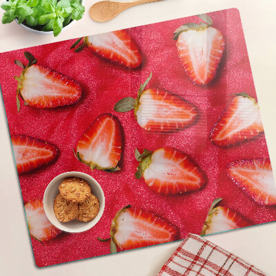 Tabla de cortar de cristal Fresas sobre un fondo rosa