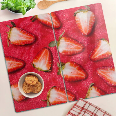 Tabla de cortar de cristal Fresas sobre un fondo rosa