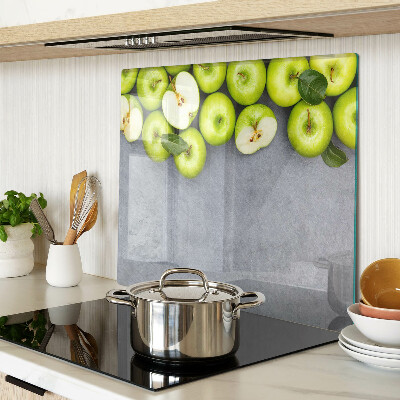 Tabla de cortar de cristal Manzanas verdes sobre una superficie gris