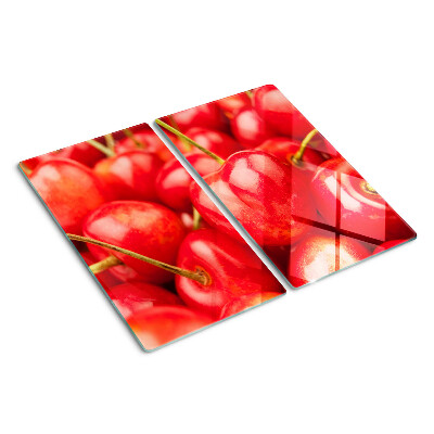 Tabla para cortar Cerezas sobre un fondo rojo