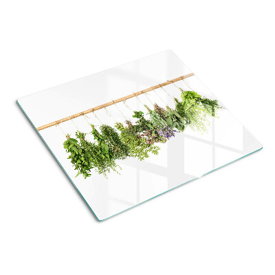 Tabla de cortar de cristal Hierbas secas en una cuerda