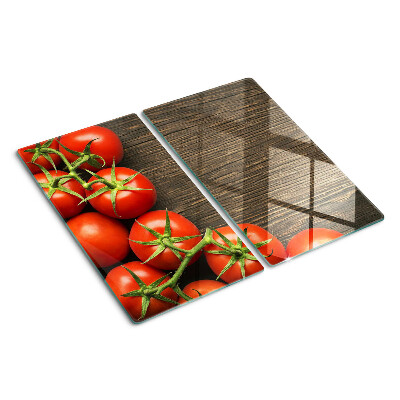 Tabla de cortar de cristal Tomates sobre un fondo de madera